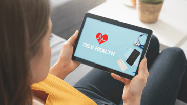 A person holding a table with the word tele health and other medical items like masks and pills against a blue background