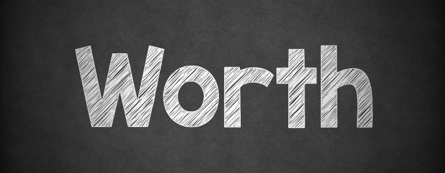 The word "worth" written on a black chalk board in white chalk. 